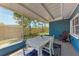 Covered patio with dining furniture, offering a cozy outdoor space for meals and relaxation at 2820 Wood St, Sarasota, FL 34237