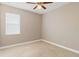 Well-lit bedroom with neutral decor and carpet flooring at 3002 Florida Elm Pl, Seffner, FL 33584