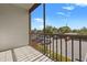 View from the balcony with tile flooring and metal railing, overlooking the parking lot at 3267 Beneva Rd # 201, Sarasota, FL 34232