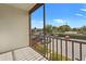 View from the balcony overlooking the parking lot and landscaping with blue skies overhead at 3267 Beneva Rd # 201, Sarasota, FL 34232