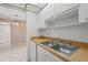 Well-lit kitchen boasts stainless steel sink and spacious counter at 3267 Beneva Rd # 201, Sarasota, FL 34232