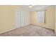 Well-lit bedroom featuring a large closet and window coverings at 3386 Oakwood N Blvd, Sarasota, FL 34237