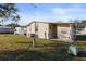 Side view of a manufactured home showcasing a large yard at 3386 Oakwood N Blvd, Sarasota, FL 34237