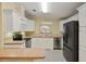 Well-equipped kitchen with white cabinets and stainless steel appliances at 3386 Oakwood N Blvd, Sarasota, FL 34237