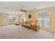 Spacious living room with a sofa, chairs, and ceiling fan at 3386 Oakwood N Blvd, Sarasota, FL 34237