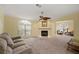 Living room with fireplace, seating area, and view to kitchen at 3386 Oakwood N Blvd, Sarasota, FL 34237
