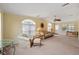 Living room with seating area, ceiling fan, and view into kitchen at 3386 Oakwood N Blvd, Sarasota, FL 34237