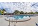 Relaxing kidney-shaped pool with lounge chairs and patio at 4153 66Th W Cir, Bradenton, FL 34209