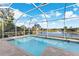 Inviting screened-in pool with a view of a serene lake at 4252 Wordsworth Way, Venice, FL 34293