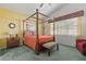 Spacious bedroom with a four-poster bed and large window at 4311 65Th E Ter, Sarasota, FL 34243