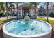 Community clubhouse with a circular fountain in front at 4311 65Th E Ter, Sarasota, FL 34243