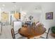 Dining area with wood table and chairs, open to the kitchen and living room at 4311 65Th E Ter, Sarasota, FL 34243