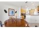 Dining area with wood table and chairs, open to the kitchen and living room at 4311 65Th E Ter, Sarasota, FL 34243