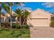 Single-story home with a two-car garage and landscaped front yard at 4311 65Th E Ter, Sarasota, FL 34243