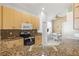 Kitchen with light wood cabinets, granite countertops, and stainless steel appliances at 4311 65Th E Ter, Sarasota, FL 34243