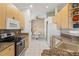 Modern kitchen boasting granite counters, stainless steel appliances, and wood cabinets at 4311 65Th E Ter, Sarasota, FL 34243