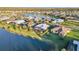 Wide aerial shot of a neighborhood featuring various homes, lakes, and lush green landscaping at 4779 Pastel Ct, Sarasota, FL 34240