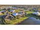 Aerial view of a residential community with well-maintained lawns, lakes, and diverse home styles at 4779 Pastel Ct, Sarasota, FL 34240