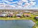 Panoramic aerial view of a residential community near a lake with mature trees and landscaping at 4779 Pastel Ct, Sarasota, FL 34240