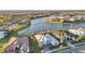 Aerial view of homes near a lake with manicured lawns and palm tree landscaping at 4779 Pastel Ct, Sarasota, FL 34240