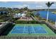 Aerial view of community amenities: pool, playground, basketball court, and scenic lake views at 4779 Pastel Ct, Sarasota, FL 34240