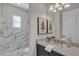 Bathroom showcasing granite countertop, vanity, framed mirror, and a walk-in shower with glass door at 4779 Pastel Ct, Sarasota, FL 34240