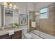 Bathroom featuring a vanity sink with granite countertop, a mirror, and a shower at 4779 Pastel Ct, Sarasota, FL 34240