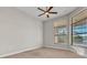 Spacious bedroom with a ceiling fan and large windows providing plenty of natural light and views at 4779 Pastel Ct, Sarasota, FL 34240