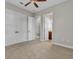 Spacious bedroom featuring a ceiling fan, carpeting, and access to an ensuite bathroom at 4779 Pastel Ct, Sarasota, FL 34240