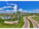 Scenic entrance to the Artistry community with beautiful landscaping and a peaceful pond at 4779 Pastel Ct, Sarasota, FL 34240