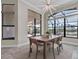 A dining room boasts contemporary lighting, a large window and views of a serene waterfront setting at 4779 Pastel Ct, Sarasota, FL 34240