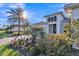 Beautifully landscaped home with palm trees and a well-maintained lawn at 4779 Pastel Ct, Sarasota, FL 34240
