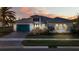 Beautiful home featuring lush landscaping, neutral color palette, and a brick driveway at 4779 Pastel Ct, Sarasota, FL 34240