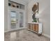 Bright foyer featuring stylish tile flooring, textured glass double doors, and a modern console with decorative artwork at 4779 Pastel Ct, Sarasota, FL 34240