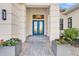 Inviting front entrance with stylish doors, modern lighting, and attractive planters at 4779 Pastel Ct, Sarasota, FL 34240