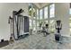 Modern gym with exercise machines, weights, and floor-to-ceiling windows showcasing a pool at 4779 Pastel Ct, Sarasota, FL 34240