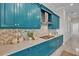 Gourmet kitchen features custom blue cabinets, white countertops, stainless steel appliances and stylish backsplash at 4779 Pastel Ct, Sarasota, FL 34240