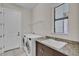 Functional laundry room with washer, dryer, sink, granite countertops, and natural light from a large window at 4779 Pastel Ct, Sarasota, FL 34240