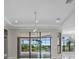 View of the living room, showing the large sliding glass doors and the view outside at 4779 Pastel Ct, Sarasota, FL 34240