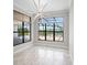 Living room with a view of the pool area and black frame windows allowing ample sunlight at 4779 Pastel Ct, Sarasota, FL 34240