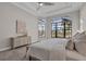 A bright main bedroom features large windows with black frames and a neutral color scheme at 4779 Pastel Ct, Sarasota, FL 34240