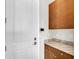 Convenient mudroom featuring custom cabinets, granite countertops, and direct access to the garage at 4779 Pastel Ct, Sarasota, FL 34240