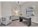 Well-lit office with a modern desk, a stylish chair, and a complementing sideboard at 4779 Pastel Ct, Sarasota, FL 34240