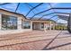 Spacious brick patio featuring an overhead screen and views of tropical landscaping at 4779 Pastel Ct, Sarasota, FL 34240