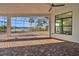 Covered brick patio with lake views beyond screened enclosure at 4779 Pastel Ct, Sarasota, FL 34240