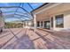 A covered patio area featuring brick pavers and a screened enclosure offers a relaxing outdoor space at 4779 Pastel Ct, Sarasota, FL 34240