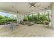 Inviting outdoor patio with comfortable seating, offering a relaxing space surrounded by greenery at 4779 Pastel Ct, Sarasota, FL 34240