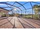 A brick-paved patio with a screened enclosure provides a stunning view of the lake at 4779 Pastel Ct, Sarasota, FL 34240