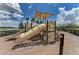 Community playground with slides and sunshade, surrounded by lush landscaping and serene views at 4779 Pastel Ct, Sarasota, FL 34240
