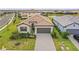 An aerial view of a single-Gathering home showcasing a beautiful tile roof and long driveway at 5107 Coral Reef Way, Bradenton, FL 34211